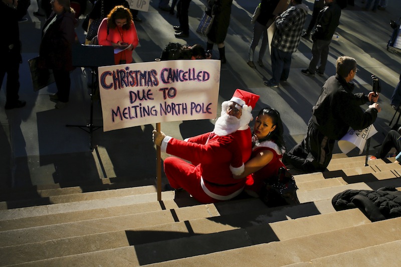 Protesters dressed as Santa Claus take part in a protest about climate change at New York City Hall steps in lower Manhattan, New York, November 29, 2015, a day before the start of the Paris Climate Change Conference. u00e2u20acu201d Reuters pic