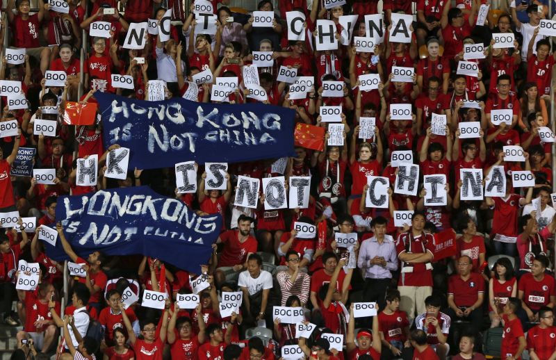 Hong Kong fans hold banners and character signs that read u00e2u20acu02dcHong Kong is not Chinau00e2u20acu2122, at the playing of the Chinese national anthem, 2018 World Cup qualifyer Hong Kong v China, in Hong Kong November 17, 2015. REUTERS/Bobby Yip