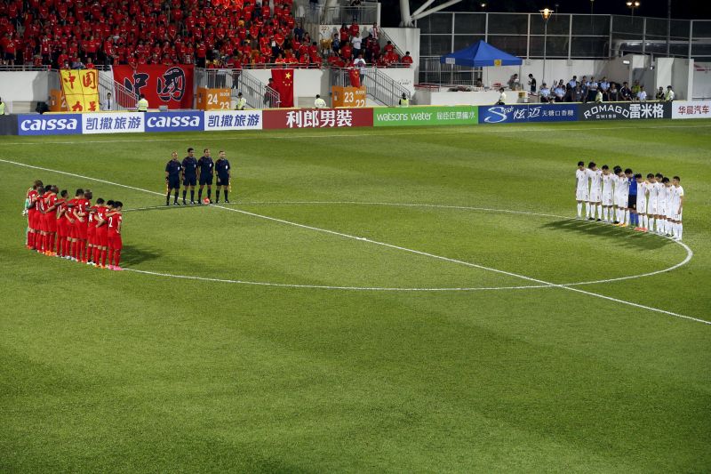 Players from Hong Kong (right) and China pay tribute to victims of the attacks in Paris.