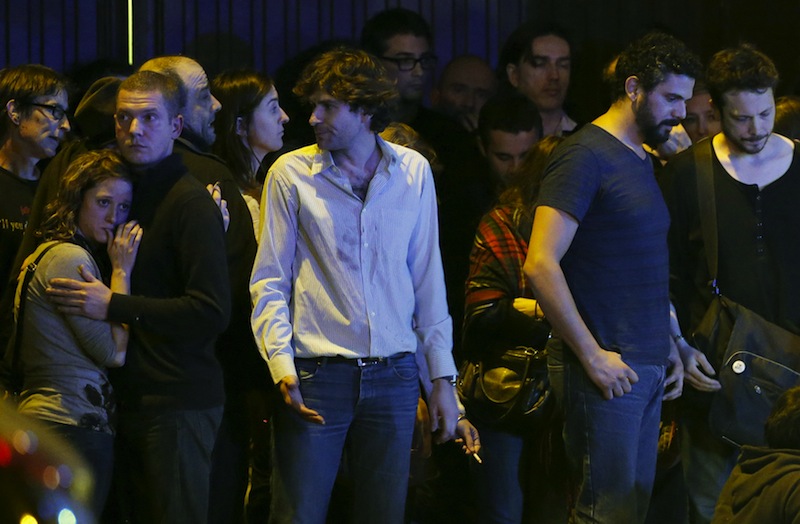 People react as they take shelter during police operations next to the Bataclan concert hall following fatal shootings in Paris, France, November 13, 2015. u00e2u20acu201d Reuters pic