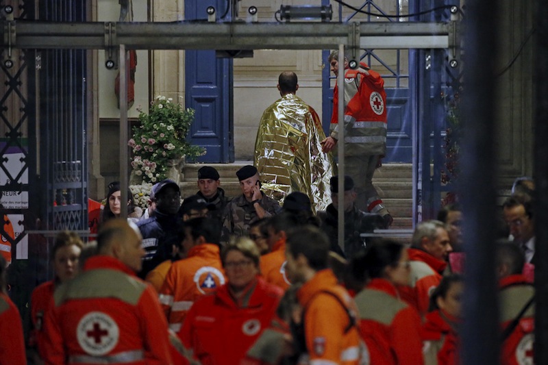 People warm up under protective thermal blankets as they walk on a street near the Bataclan concert hall following fatal attacks in Paris, France, November 14, 2015.u00c2u00a0u00e2u20acu201d Reuters pic