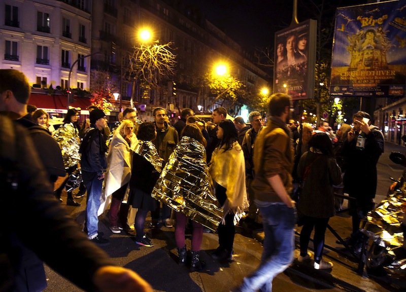 People warm up under protective thermal blankets as they gather on a street near the Bataclan concert hall following fatal attacks in Paris, France, November 14, 2015. u00e2u20acu201d Reuters pic
