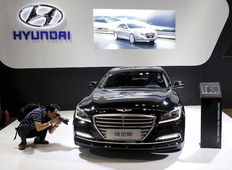 A visitor takes picture of Hyundai Genesis model during the Imported Auto Expo in Beijing, in this September 24, 2015 file photo. u00e2u20acu201d Reuters picn