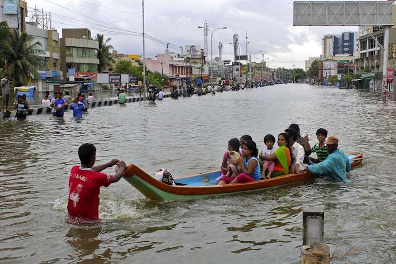 People travel on a boat as they move to safer places through a flooded road in Chennai, India, December 2, 2015. u00e2u20acu201d Reuters pic