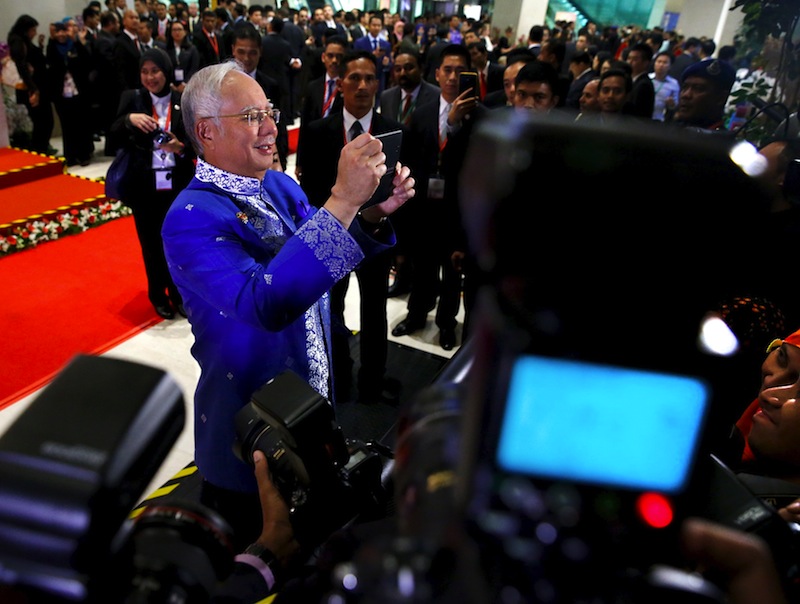 Malaysian Prime Minister Najib Razak takes pictures of gathered news photographers before the start of the Asean Summit gala dinner in Kuala Lumpur, Malaysia, November 21, 2015. u00e2u20acu201d Reuters pic