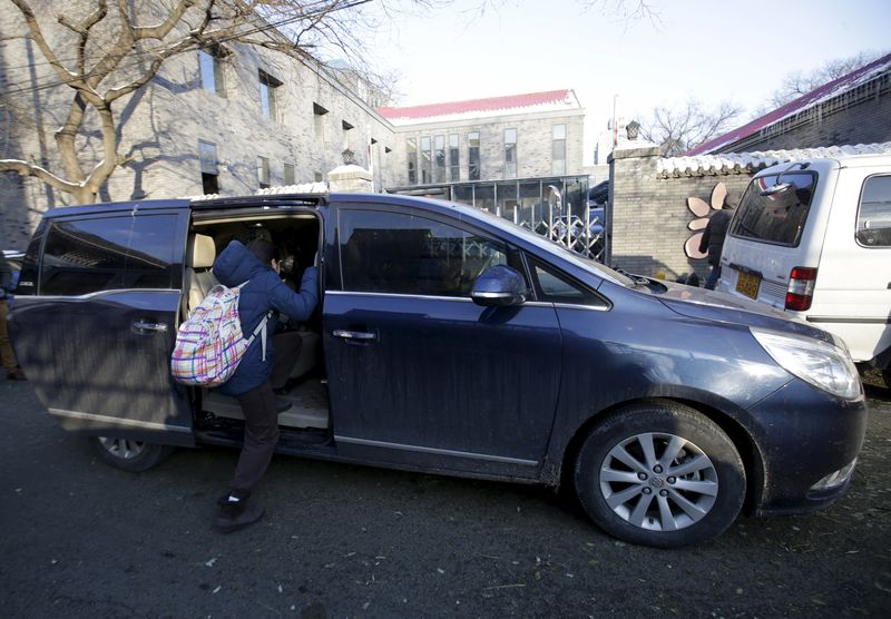 A primary school student gets into a minivan as her mother picks her up outside her school, in Beijing, November 25, 2015. u00e2u20acu201d Reuters pic