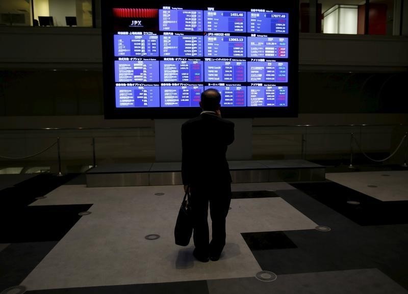 A man looks at an electronic board showing Japan's Nikkei average and related indices at the Tokyo Stock Exchange in Tokyo August 26, 2015. u00e2u20acu201d Reuters pic