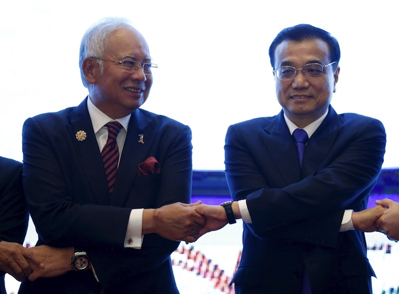 Datuk Seri Najib links hands with China's Premier Li Keqiang during the 27th Association of Southeast Asian Nations summit in Kuala Lumpur, Malaysia, November 22, 2015. u00e2u20acu201d Reuters pic