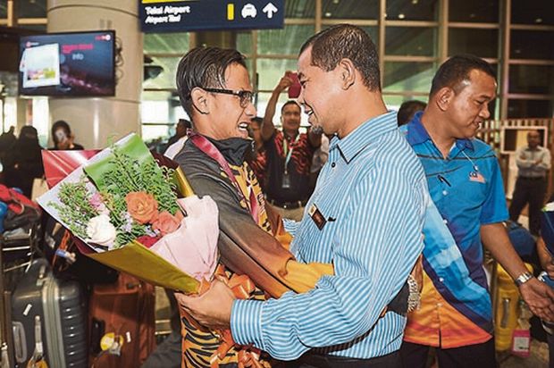 Shapawi greets Latif during his arrival from Qatar at KL International Airport yesterday. u00e2u20acu201d Bernama pic