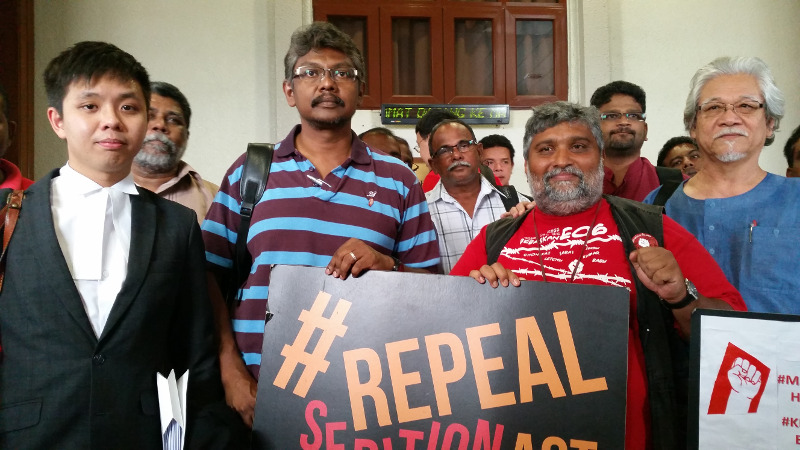 Parti Sosialis Malaysia (PSM) central committee member S. Arutchelvan (in red) was today charged with sedition over a criticism of a Federal Court decision. He is shown with PSM chairman Dr Mohd Nasir Hashim (front right) and his lawyer New Sin Yew ( fron