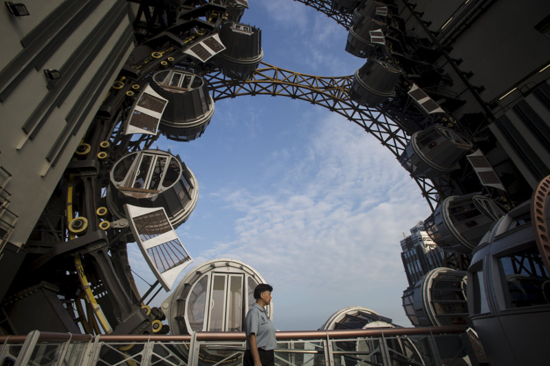 The Golden Reel Ferris wheel with its steampunk-inspired cabins is seen between the hotel towers at Studio City in Macau, October 27, 2015.