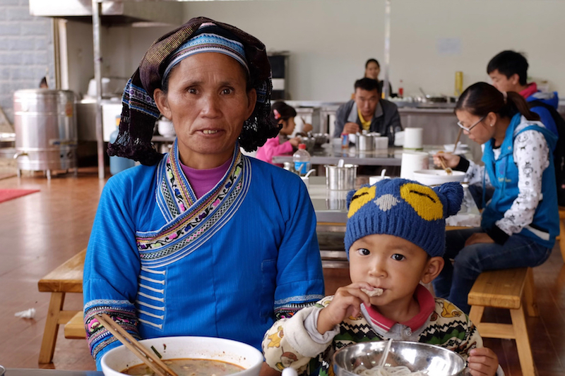 A woman and her grandchild eat noodles in China for breakfast. — Picture by Josh Wand/Reuters