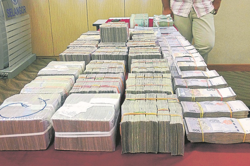 The RM2.7 million cash seized by police from the home of one of the suspects in Bukit Ceylon on Sunday morning. u00e2u20acu201d Picture by Emmanuel Santa Maria Chin