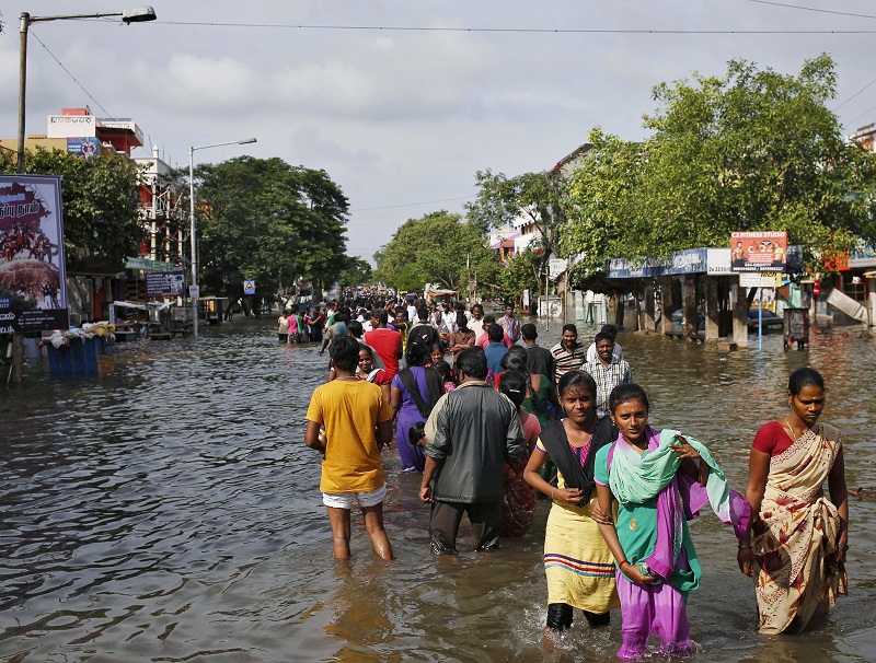 Residents wade through a flooded street as they evacuate their homes in Chennai, in the southern state of Tamil Nadu, India December 3, 2015. — Reuters pic