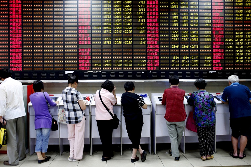 Investors look at computer screens showing stock information at a brokerage house in Shanghai, China, in this July 8, 2015 file photo. u00e2u20acu201d Reuters pic