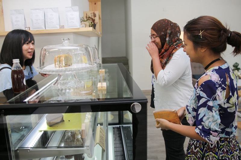 Customers checking out the cakes for sale.