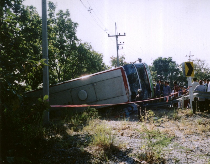 A bus lies beside the road near the northern Thai town of Chiang Mai after it crashed 25 November. u00e2u20acu201d AFP pic