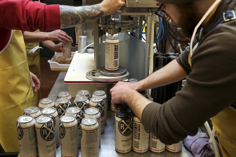Cans of the ESB are filled one at a time and then weighed at Rockaway Brewery in New York, November 23, 2015. — Picture by Richard Perry/The New York Times