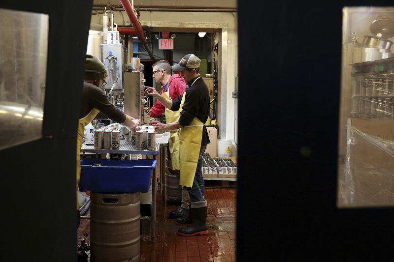A team fills cans of ESB, an extra special bitter beer, at Rockaway Brewery in New York, November 23, 2015. — Picture by Richard Perry/The New York Times