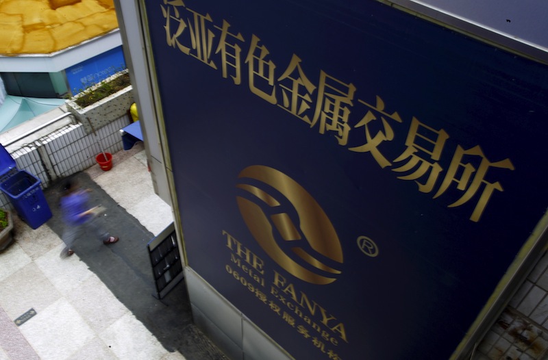 A woman walks past the company logo of the closed exchange centre of the Fanya Metal Exchange in downtown Kunming, Yunnan province, China, September 22, 2015. u00e2u20acu201d Reuters pic