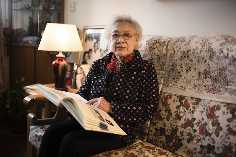 Qin Yi looks through old photos from her days as an actress, at her apartment in Shanghai November 18, 2015. u00e2u20acu201d Picture by Eric LeLeu/The New York Times