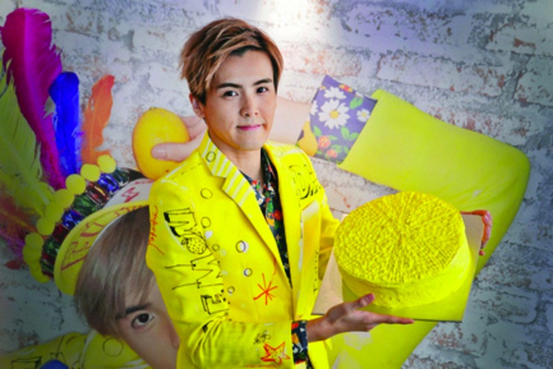 Local singer Derrick Hoh with a cake shaped like a lemon. u00e2u20acu201d TODAY pic