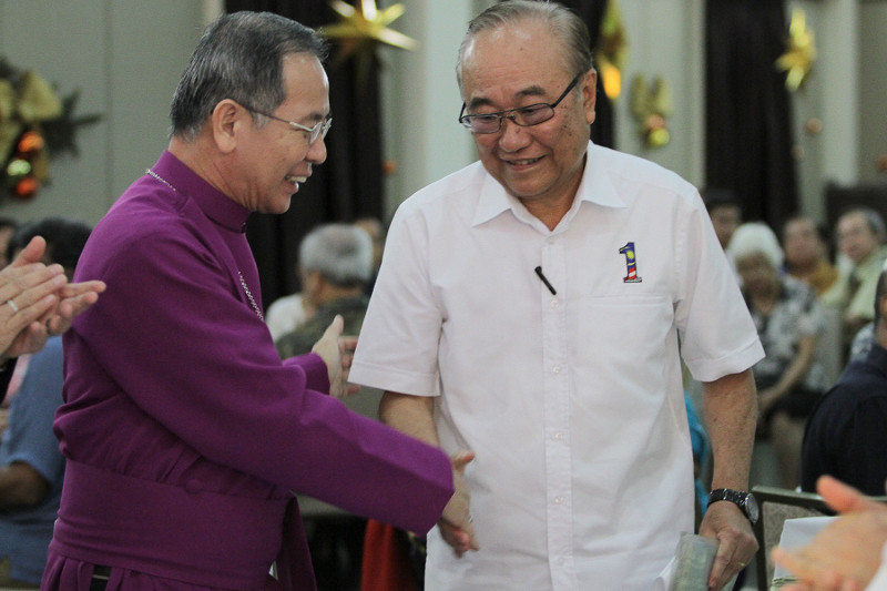 Minister in the Prime Minister's Department, Datuk Paul Low (right) shakes hands with Archbishop-Elect Datuk Ng Moon Hing at the Christian Federation of Malaysia high tea on Dec 25, 2015 in Kuala Lumpur. u00e2u20acu201d Picture by Yusof Mat Isa