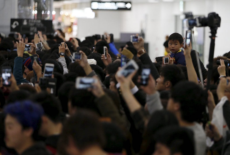 A child wearing Barcelona jersey waits for the teamu00e2u20acu2122s arrival at Narita International airport near Tokyo December 14, 2015. u00e2u20acu201d Reuters pic