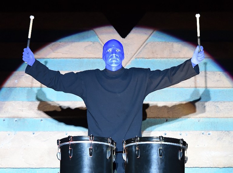 A member of Blue Man Group plays drums as he arrives on top of the new Blue Man Theatre to celebrate the launch of a new show in Las Vegas November 12, 2015. u00e2u20acu201d AFP pic