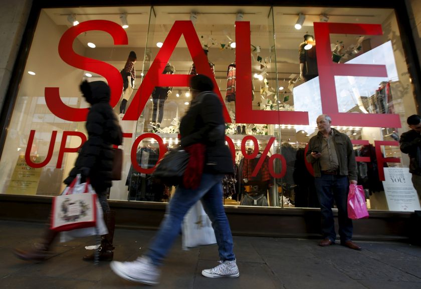 Shoppers walk past pre Christmas u00e2u20acu02dcsaleu00e2u20acu2122 signs on Oxford Street, London, December 20, 2015. u00e2u20acu201d Reuters pic
