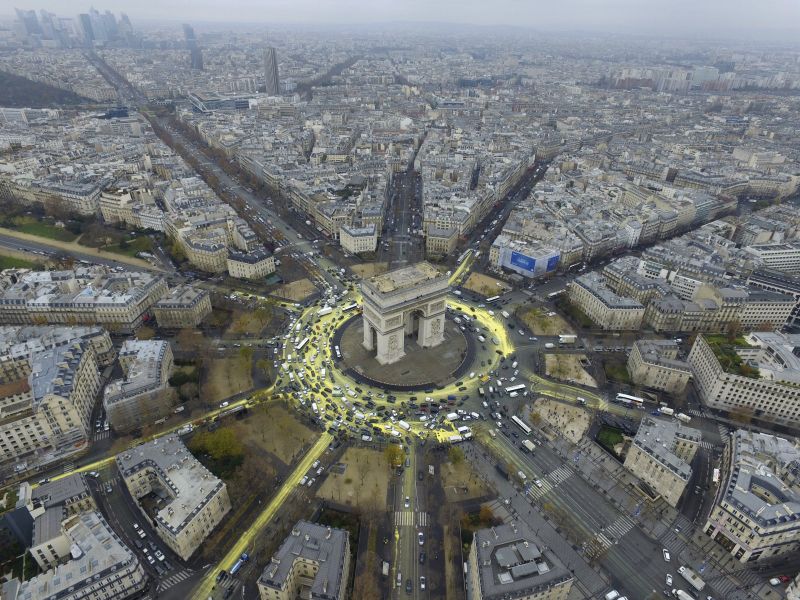 Yellow paint, symbolising sun and rays, around Arc de Triomphe, protest on Champs Elysees avenue, World Climate Change Conference 2015 (COP21), photo taken and distributed December 11, 2015, by Greenpeace. REUTERS/Greepeace