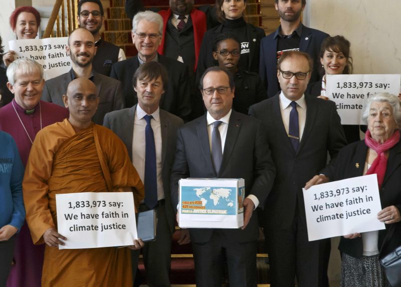 France President Francois Hollande (C) at Elysee Palace, December 10, 2015, with religious figures holds a box containing an international petition to support the climate talks, World Climate Change Conference (COP21) in Le Bourget. REUTERS/Michel Euler/P