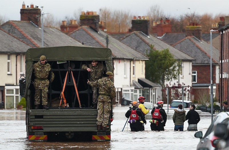 Members of the British army assist the emergency services in a flooded street in Carlisle, northern England, on December 6, 2015. u00e2u20acu201d AFP pic