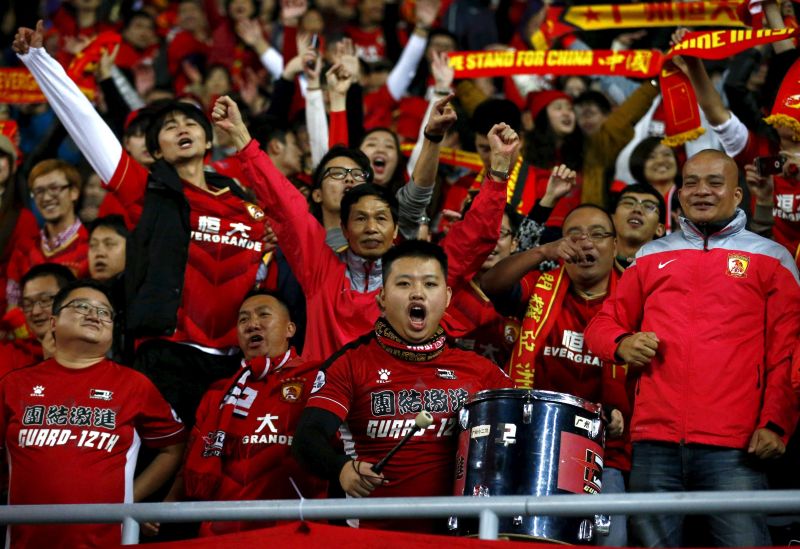 Fans of Chinau00e2u20acu2122s Guangzhou Evergrande celebrate after the team won their Club World Cup quarter-final against Mexicou00e2u20acu2122s Club America in Osaka, western Japan, December 13, 2015. REUTERS/Thomas Peter