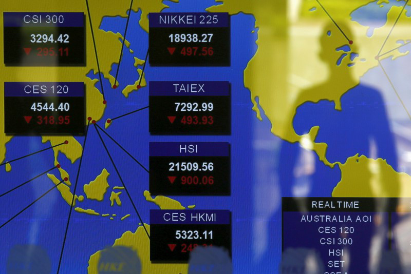 A passer-by is reflected on a panel displaying Asian market indexes at the Hong Kong Stocks Exchange in Hong Kong, China August 24, 2015. u00e2u20acu201d Reuters pic