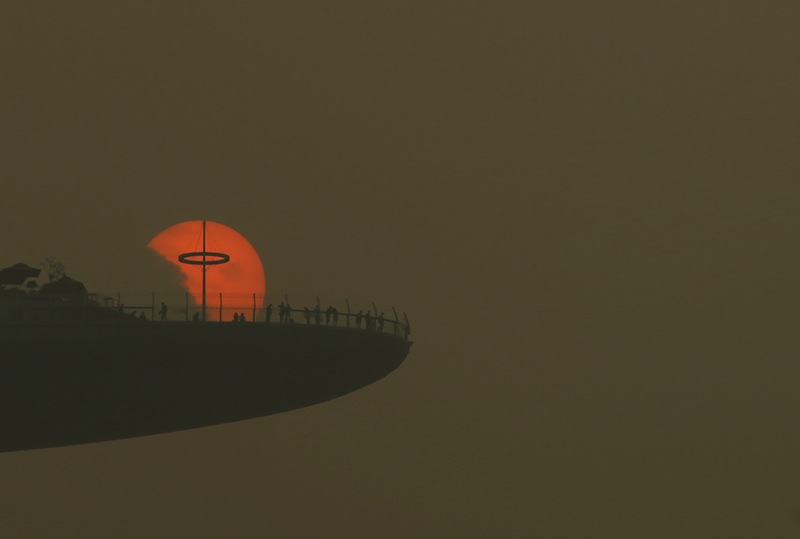 People watch the sun set from the observatory deck of the Marina Bay Sands hotel in Singapore October 5, 2015. u00e2u20acu201d Reuters pic