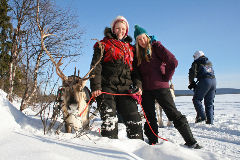 Leigh Ann Henion, (above right) with a reindeer herder in Sweden where she was in pursuit of the northern lights. u00e2u20acu201d The New York Times pic