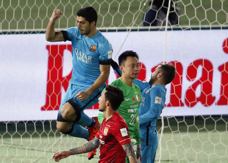 Barcelona's Luis Suarez (left) celebrates after scoring the third goal from the penalty spot and completing his hat-trick during their Club World Cup semi-final match against Guangzhou Evergrande in Yokohama December 17, 2015. u00e2u20acu201d Reuters pic 