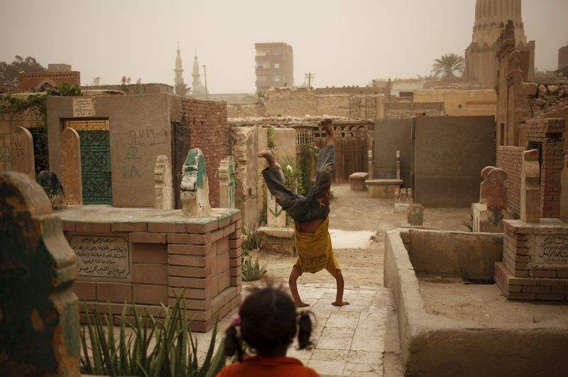 A boy plays near tombstones in the Cairo Necropolis Egypt, October 23, 2015. u00e2u20acu201d Reuters pic