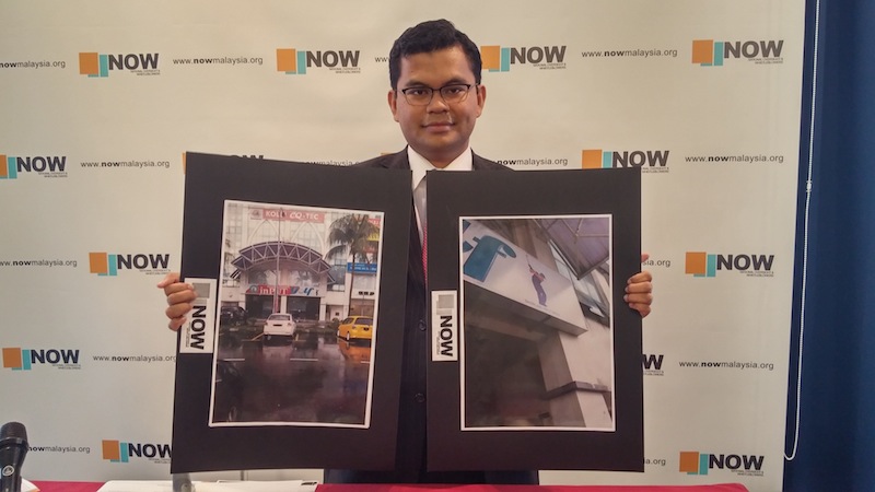 NOW director Akmal Nasir holding up photos of the purported golf simulator centre owned by Yayasan Pembangunan Ekonomi Islam Malaysia (Yapeim) at the press conference in Sungai Besi. u00e2u20acu201d Picture by Yiswaree Palansamyn