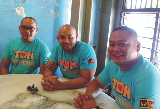 (From left) Bruce, Colin and Ernest takes a breather during a shelter home refurbishment project recently.