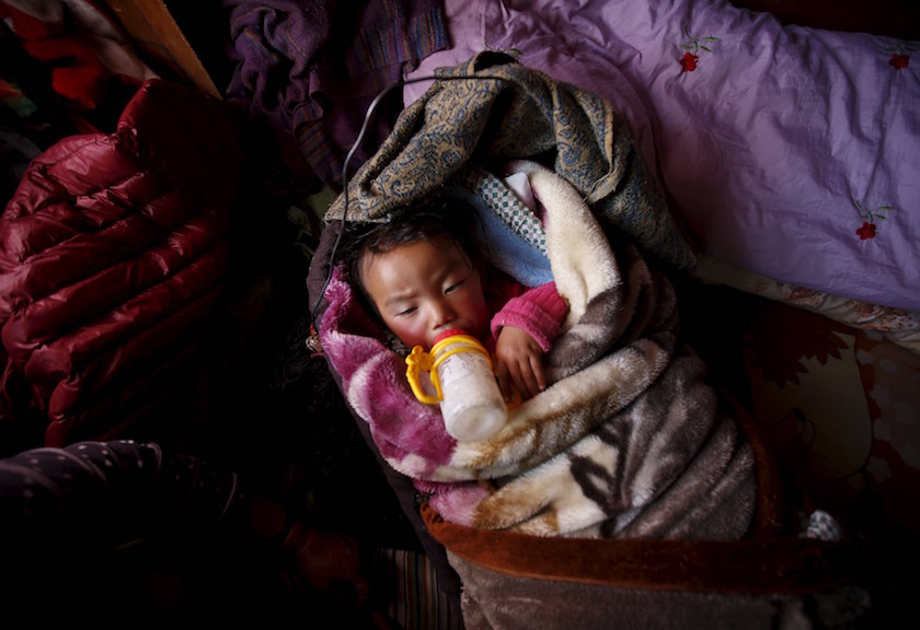 Pasang Choti Sherpa, whose father, Lakpa Sherpa, who was among the 16 sherpas who died in the avalanche on April 18, 2014, lies on her bed inside her house in Khumjung, a typical Sherpa village in Solukhumbu District, also known as the Everest region, in this picture taken November 30, 2015. — Reuters pic
