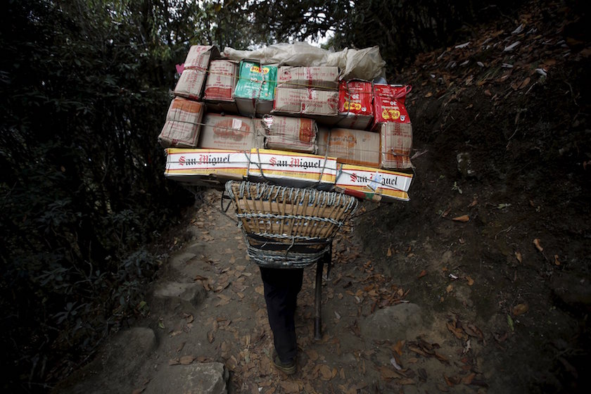 A porter carrying goods heads towards Namche, in Solukhumbu district, also known as the Everest region, in this picture taken November 28, 2015. — Reuters pic