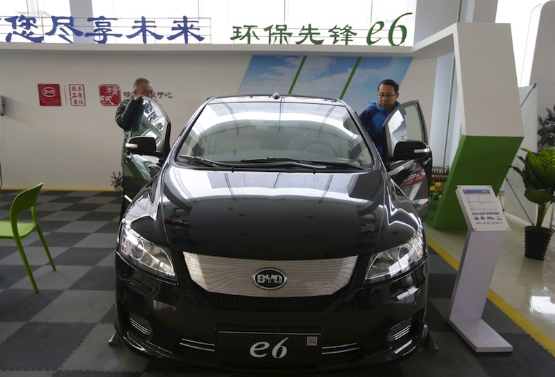 Customers check a BYD e6 electric car at a dealership in Beijing, China, December 9, 2015. Picture taken December 9, 2015. u00e2u20acu201d Reuters pic