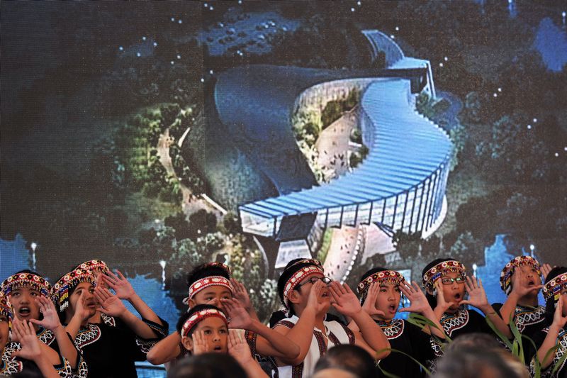 Young members of a local art group perform in front of an image of the new National Palace Museum branch during its opening ceremony in the southern Taiwan city of Chiayi on December 28, 2015. u00e2u20acu201d AFP pic