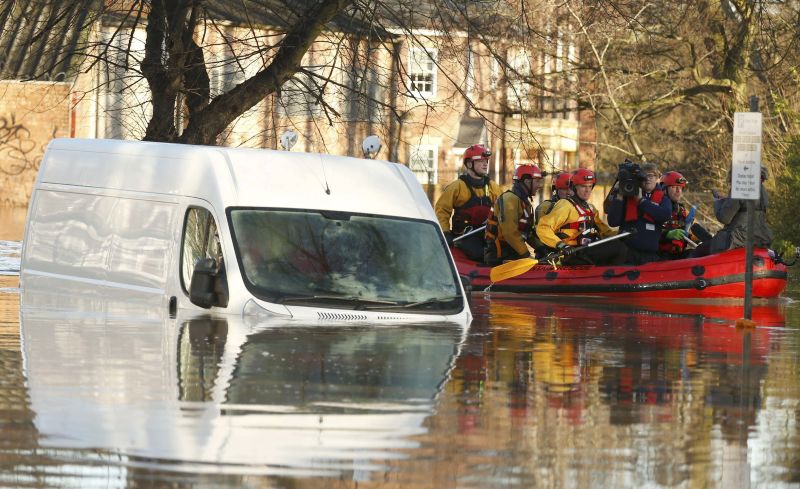 Emergency services navigate a flooded street in York, northern England, December 27, 2015. REUTERS/Phil Noble
