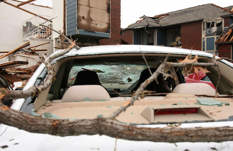 Debris and a damaged car are pictured at the Lake Village West apartment complex from a tornado in Garland, Texas, December 28, 2015. u00e2u20acu201d Reuters pic