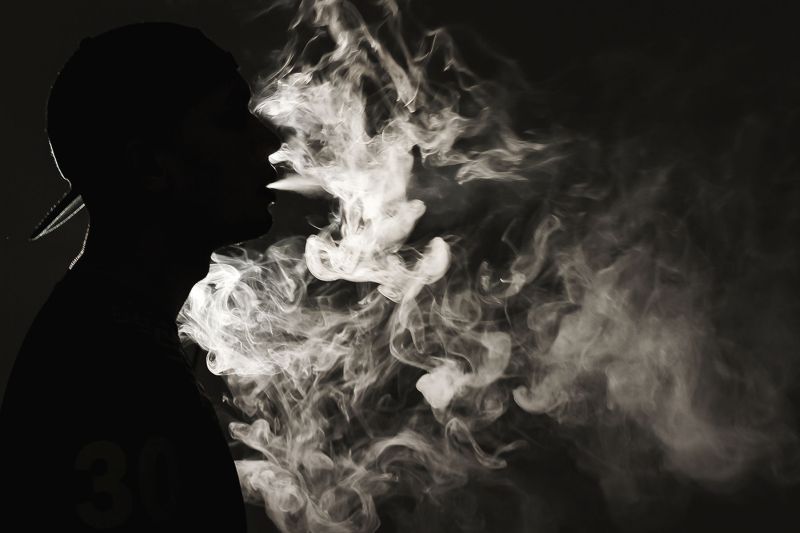 Portrait of a man vaping with his face partially covered by vapour. u00e2u20acu2022 Picture by Yusof Mat Isa