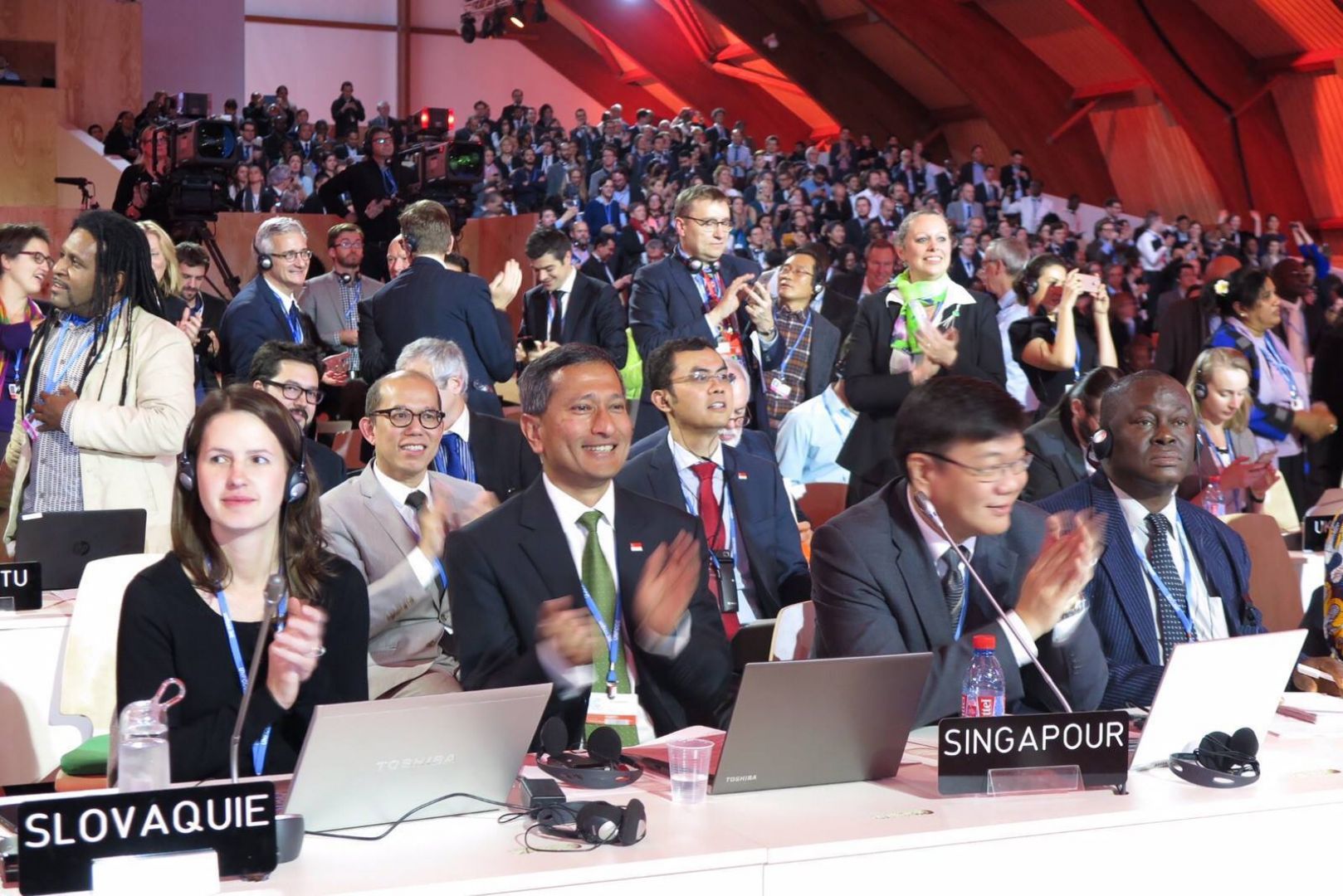 Dr Vivian Balakrishnan (second from left) and Chief Negotiator Mr Kwok Fook Seng (third from left) applauding at the Paris Climate Conference. u00e2u20acu201du00c2u00a0TODAY pic