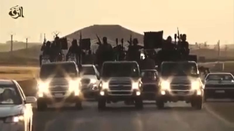 An image grab taken from a video released by Islamic State groupu00e2u20acu2122s official Al-Raqqa site via YouTube on September 23, 2014, allegedly shows Islamic State (IS) group recruits riding in armed trucks in an unknown location. u00e2u20acu201d AFP pic